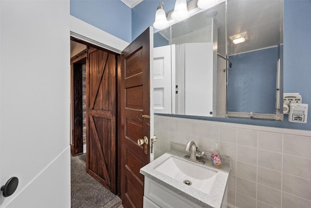 bathroom featuring vanity and tile walls