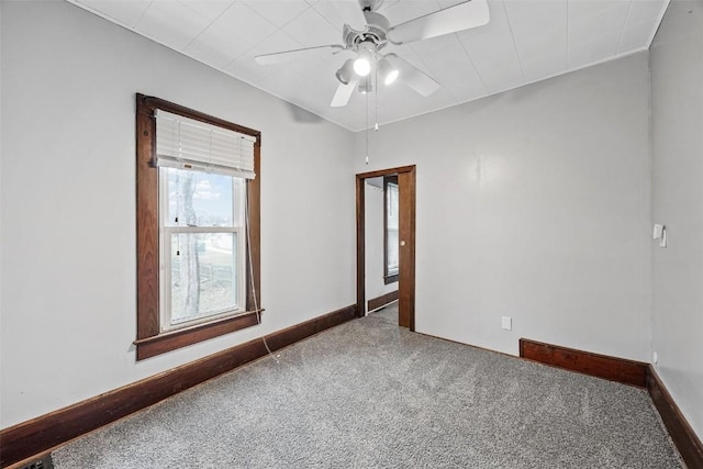 spare room featuring ceiling fan and carpet floors