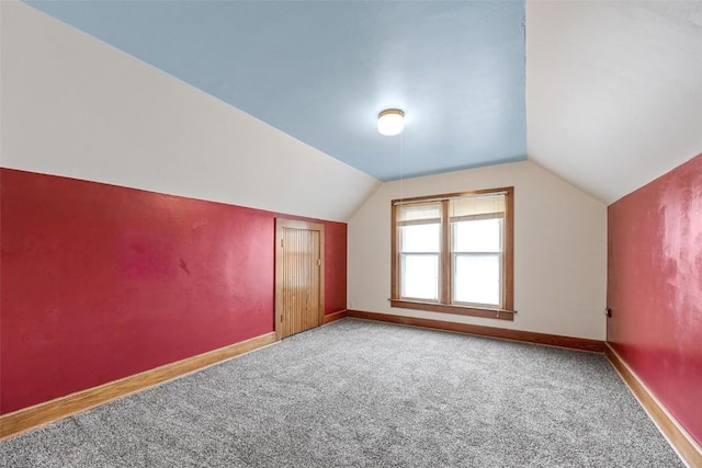 bonus room featuring light colored carpet and lofted ceiling