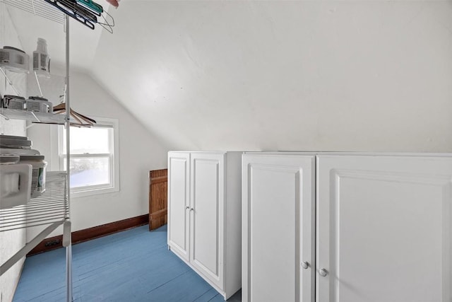 additional living space featuring light hardwood / wood-style flooring and lofted ceiling