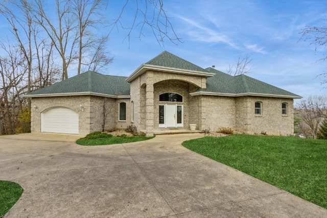 view of front of house with a front yard and a garage