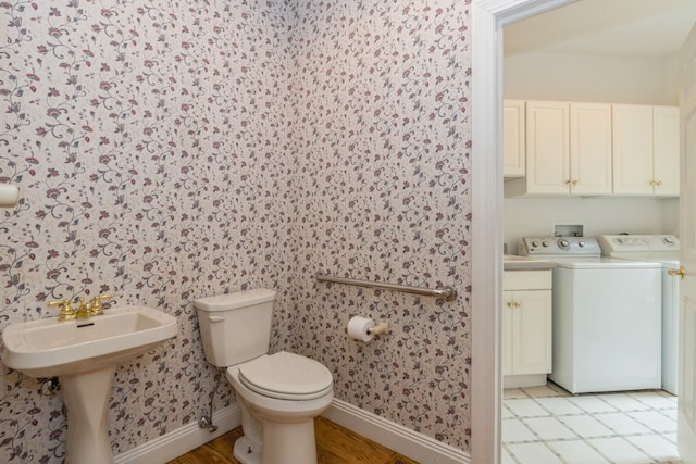 bathroom featuring tile patterned flooring, separate washer and dryer, and toilet