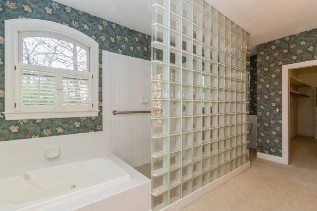 bathroom featuring shower with separate bathtub