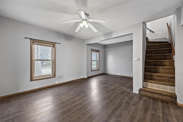 spare room featuring ceiling fan, plenty of natural light, and dark wood-type flooring