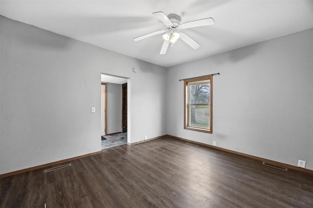 empty room with ceiling fan and dark wood-type flooring