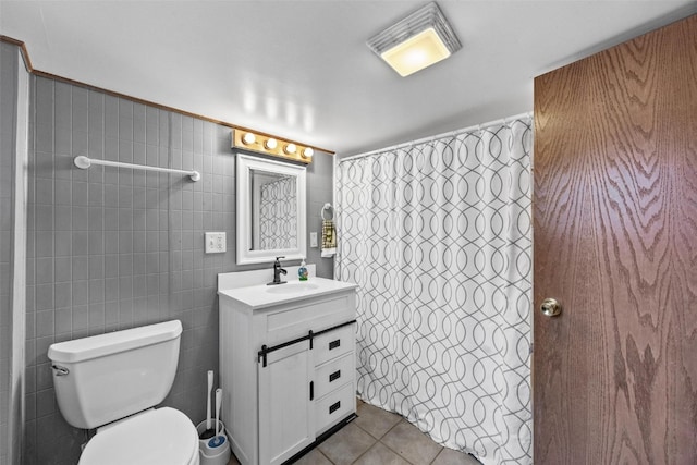 bathroom featuring tile patterned flooring, toilet, vanity, tile walls, and a shower with shower curtain