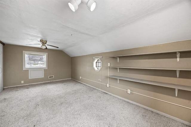 bonus room with ceiling fan, light colored carpet, a textured ceiling, and vaulted ceiling