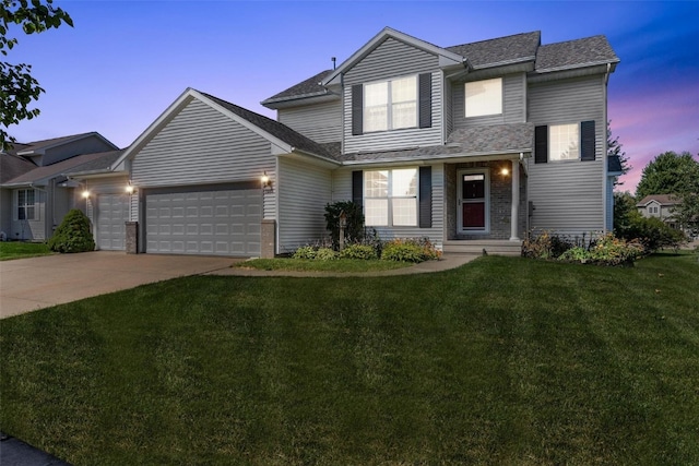 view of front facade with a lawn and a garage