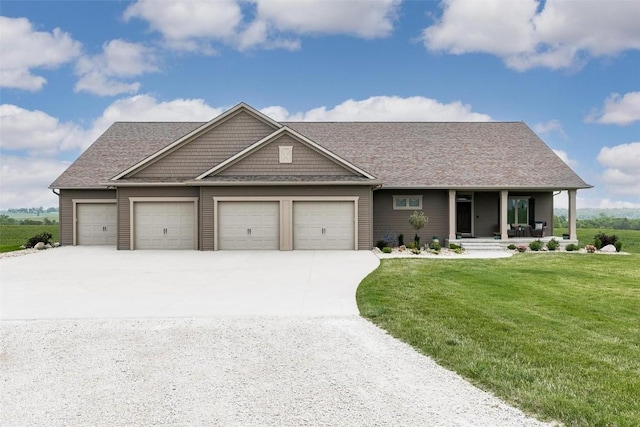 view of front of house featuring a garage, a porch, and a front yard