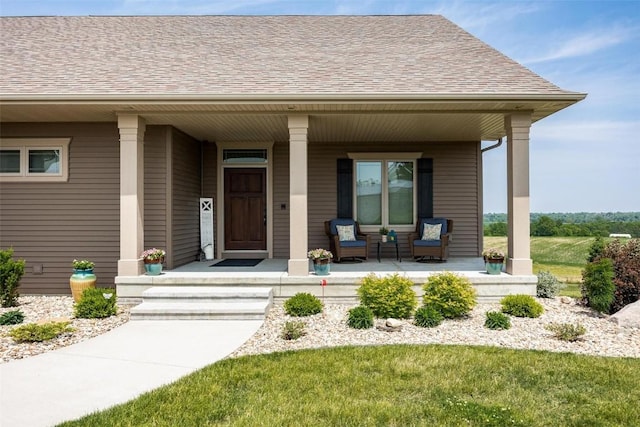 property entrance featuring covered porch and a lawn