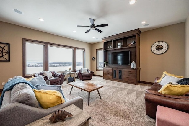 living room featuring light colored carpet and ceiling fan