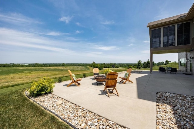 view of patio / terrace with a rural view and a fire pit