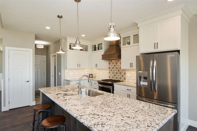 kitchen with custom exhaust hood, white cabinets, sink, dark hardwood / wood-style floors, and appliances with stainless steel finishes