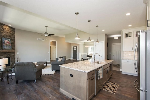 kitchen featuring white cabinetry, sink, dark hardwood / wood-style flooring, a center island with sink, and appliances with stainless steel finishes