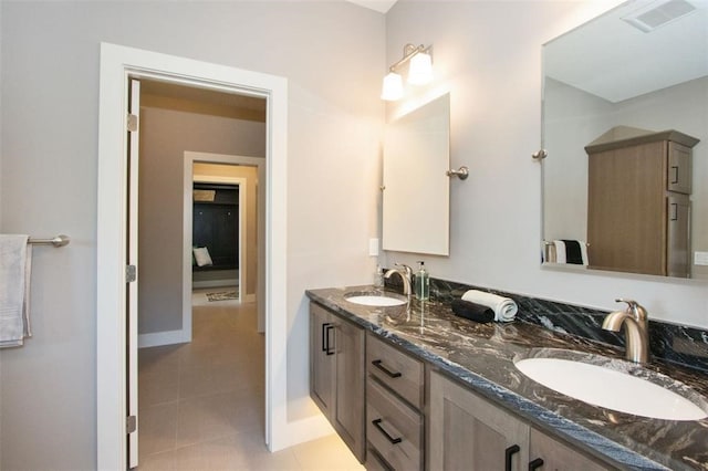 bathroom with tile patterned flooring and vanity