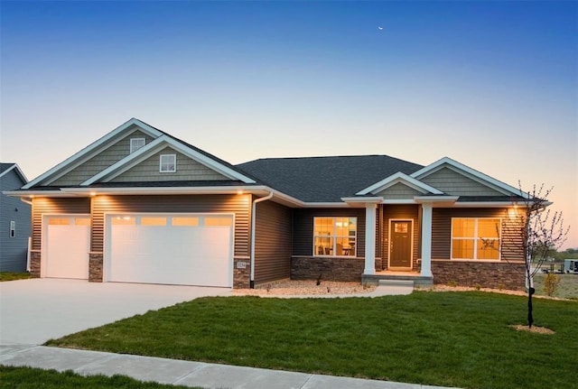 craftsman-style house with a yard and a garage