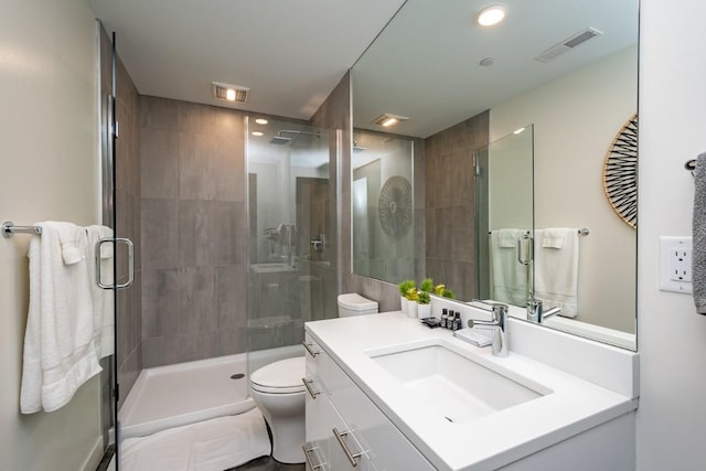 bathroom with vanity, toilet, and walk in shower