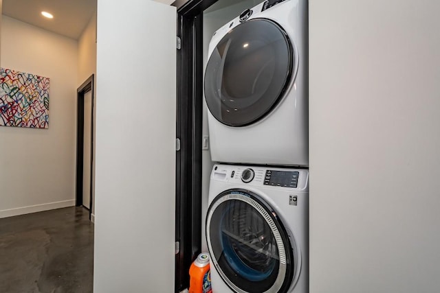 laundry room featuring stacked washer / drying machine