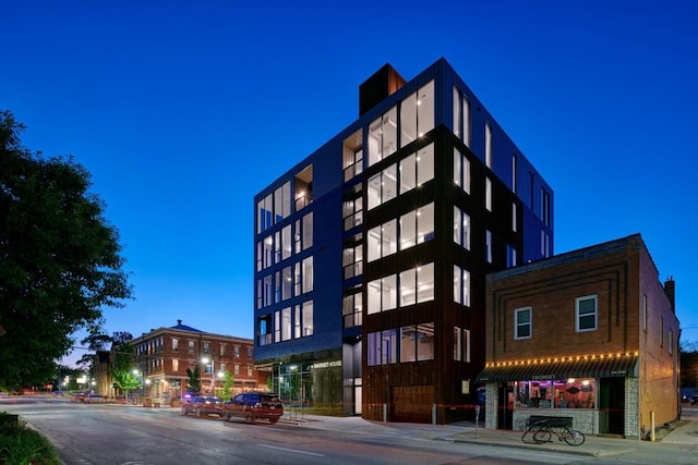 view of outdoor building at dusk