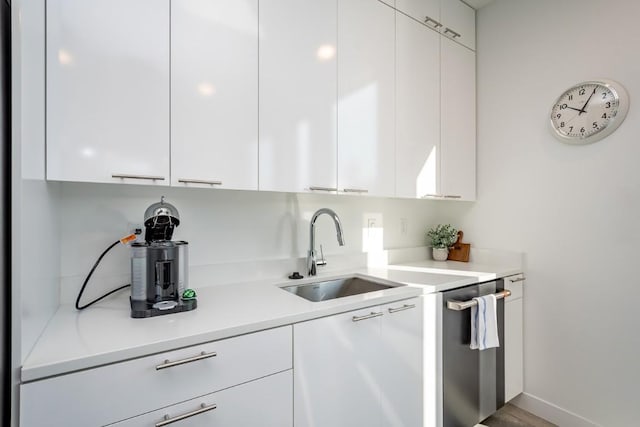 kitchen featuring white cabinetry and sink