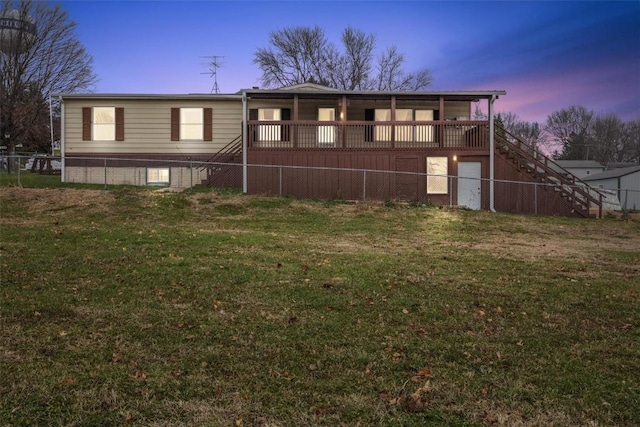 view of front of property with a yard and a wooden deck