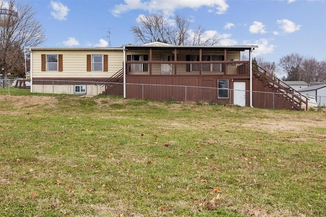 back of property with a lawn and a deck