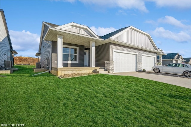 view of front of house featuring central AC, a front yard, and a garage