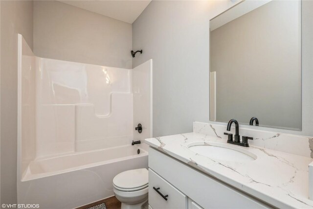 full bathroom with shower / tub combination, vanity, and toilet