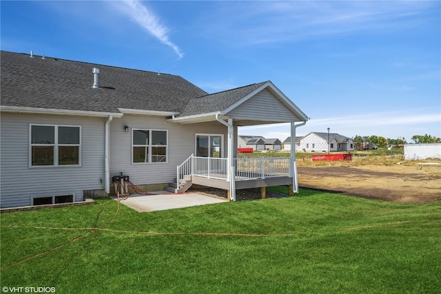 rear view of house with a lawn and a patio area