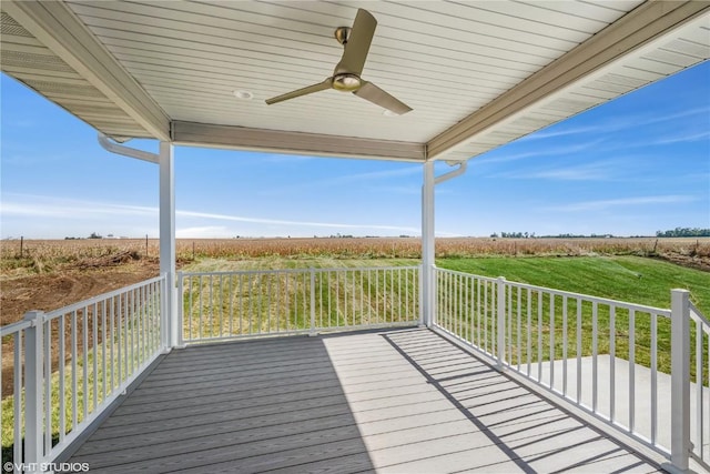 wooden terrace featuring ceiling fan and a rural view