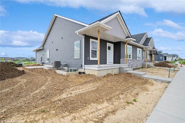 2362 Bluegrass St, Marion, IA 52302 - view of property exterior with central AC unit, a porch, and board and batten siding