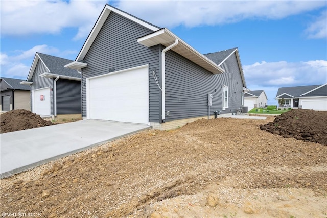 2362 Bluegrass St, Marion, IA 52302 - view of side of home featuring a garage and concrete driveway