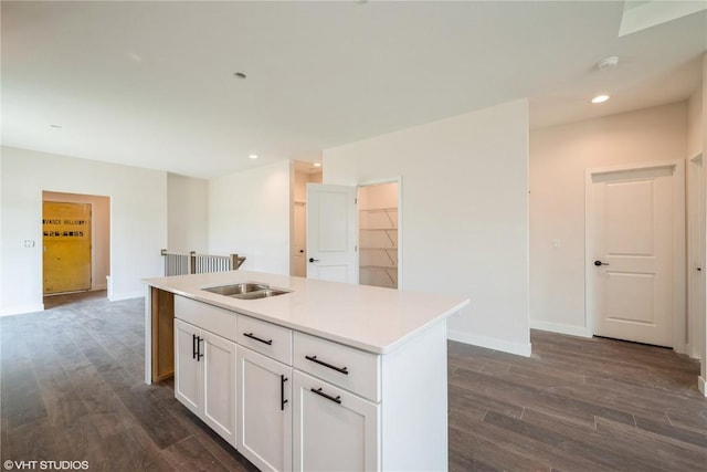 2362 Bluegrass St, Marion, IA 52302 - kitchen with dark wood-style flooring, recessed lighting, a center island with sink, white cabinetry, and light countertops