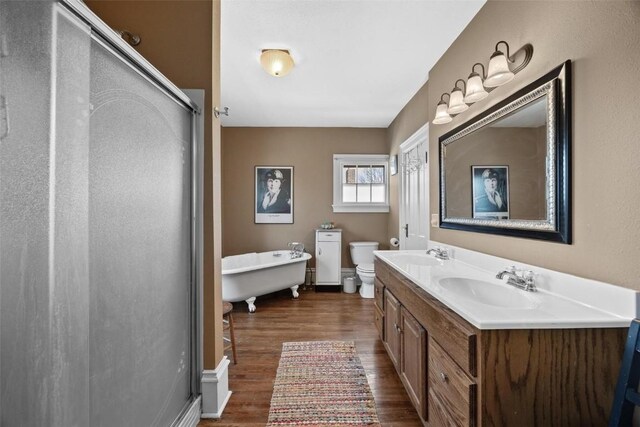 full bathroom featuring hardwood / wood-style floors, vanity, toilet, and independent shower and bath