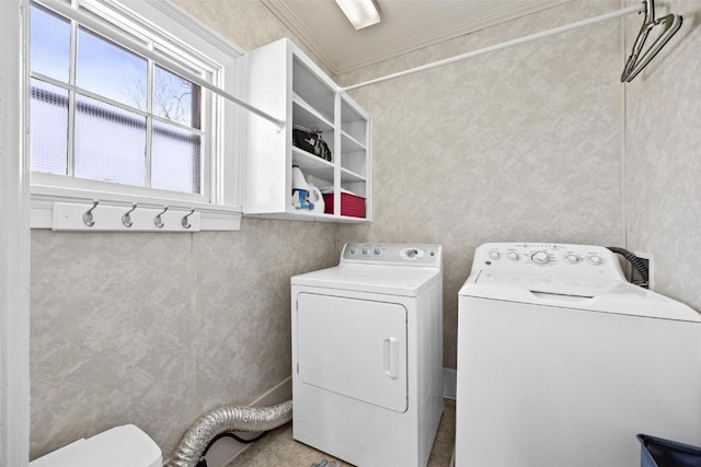 laundry area featuring washer and clothes dryer and crown molding