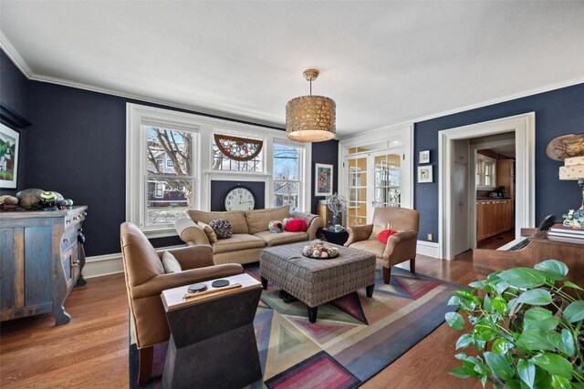 living room with hardwood / wood-style floors, french doors, and ornamental molding