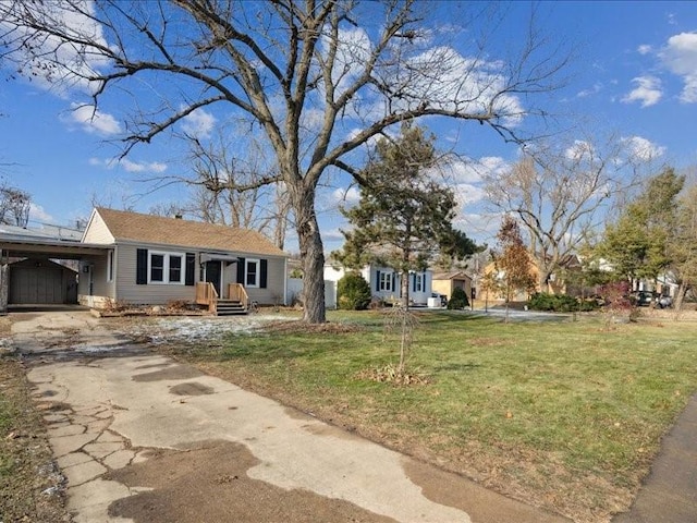 view of front facade featuring a front lawn and a carport