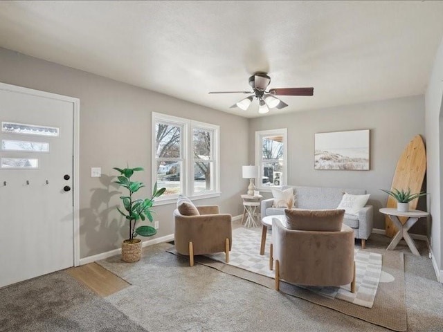 carpeted living room featuring ceiling fan