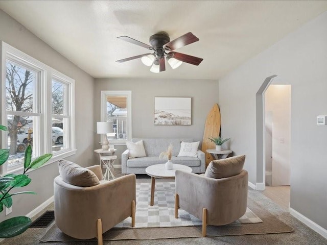 carpeted living room featuring ceiling fan