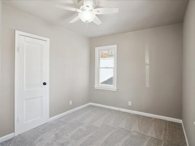 unfurnished room featuring ceiling fan and light colored carpet