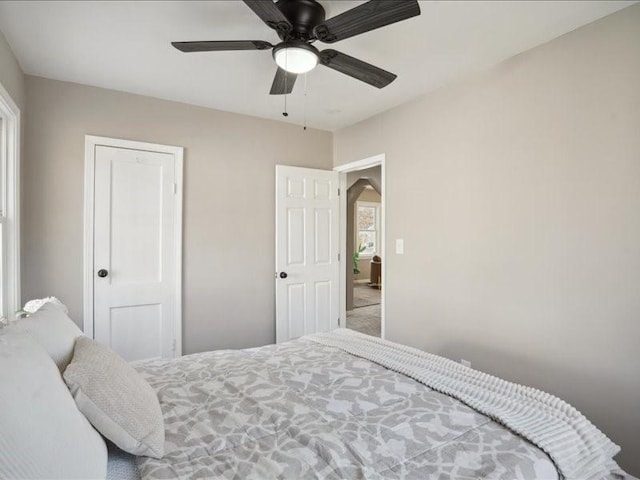 carpeted bedroom featuring ceiling fan and a closet