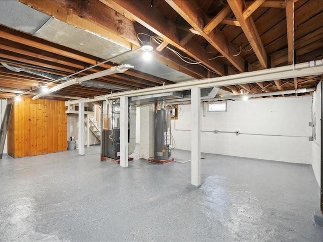 basement featuring heating unit and water heater