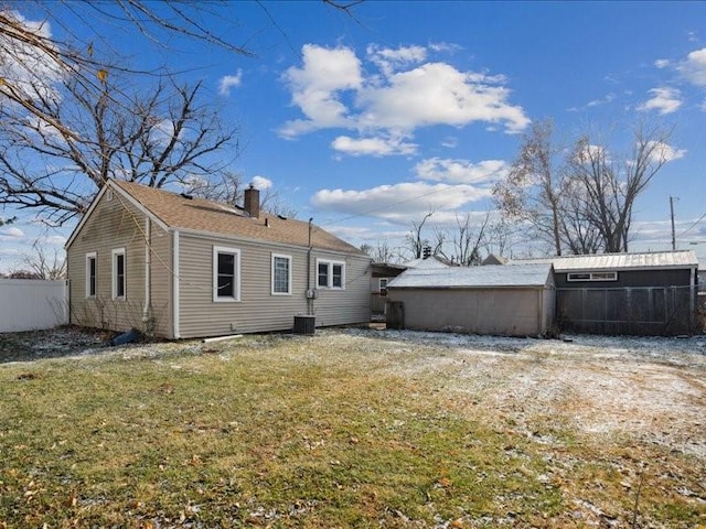 rear view of house with a yard