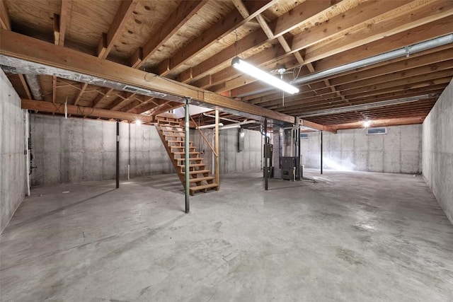 basement featuring gas water heater and heating unit