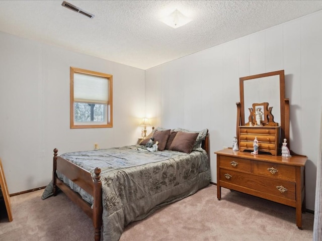 carpeted bedroom featuring a textured ceiling