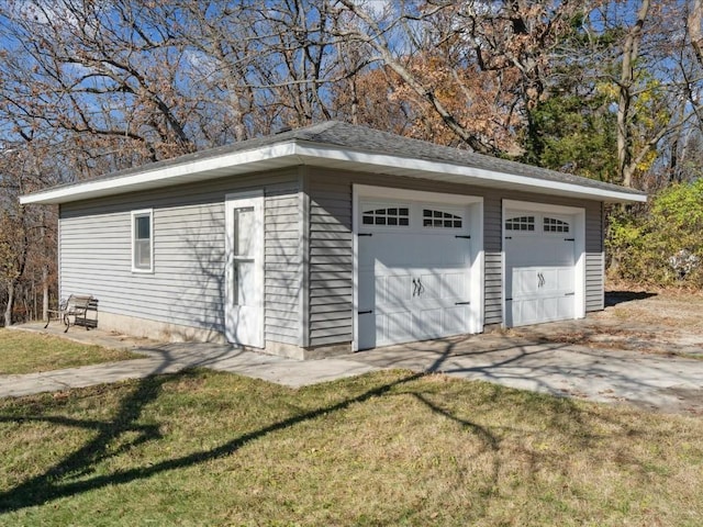 garage featuring a lawn