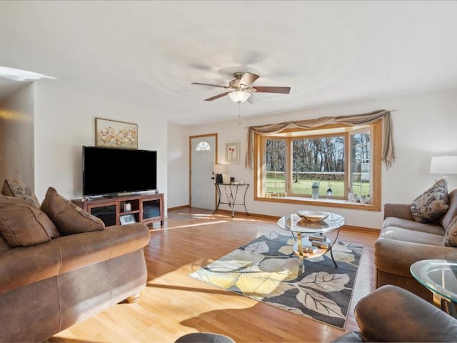 living room with light hardwood / wood-style floors and ceiling fan