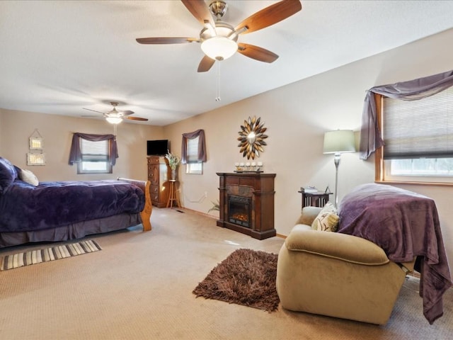 carpeted bedroom with multiple windows and ceiling fan