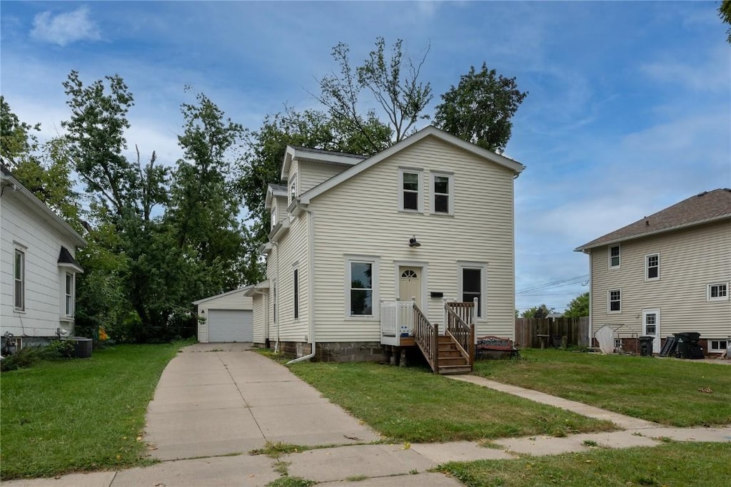 front of property featuring an outdoor structure, a front yard, and a garage