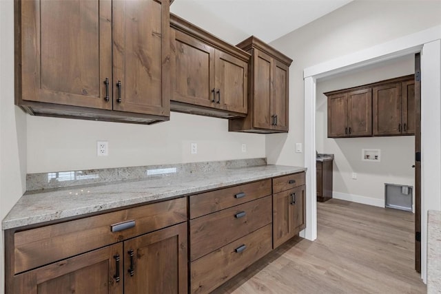 kitchen featuring light hardwood / wood-style floors and light stone counters